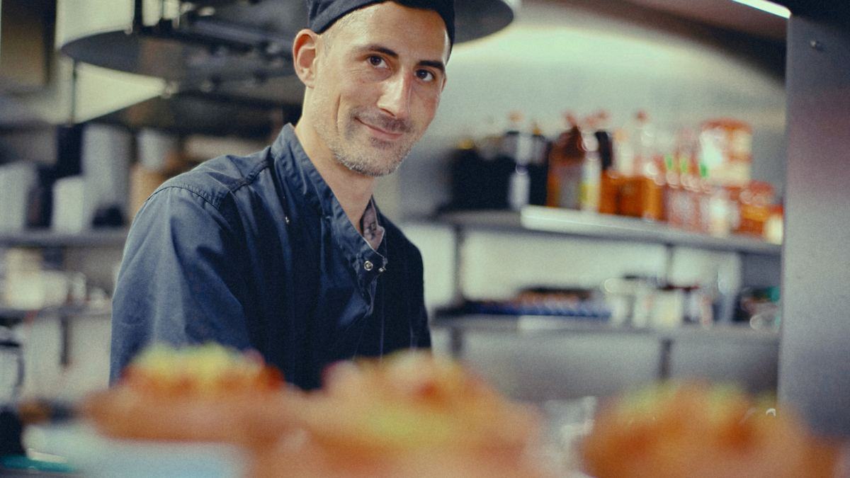 A Moshimo chef in the kitchen, plates on the pass